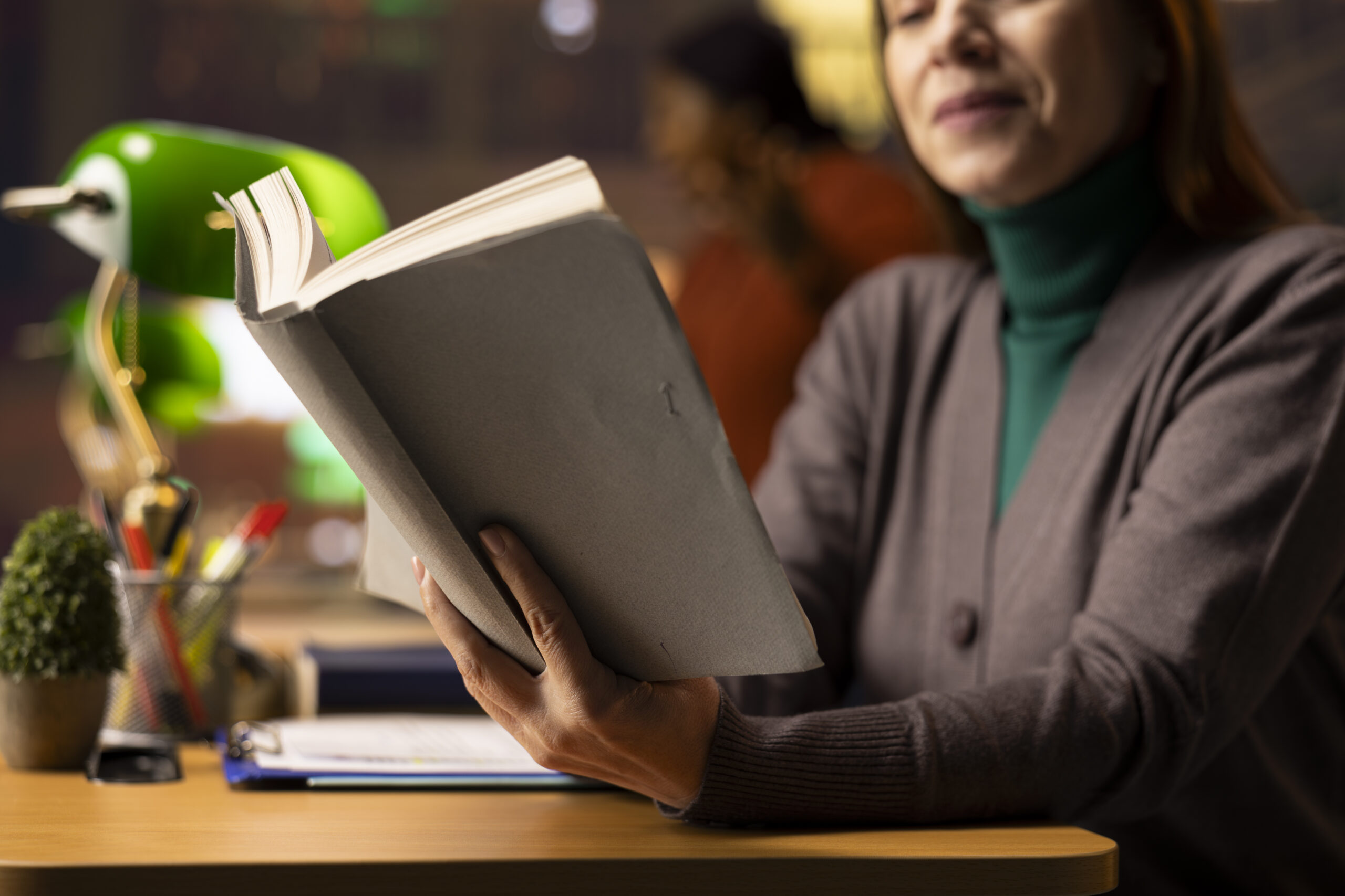 Mature woman in a study room reading books and archived documents
