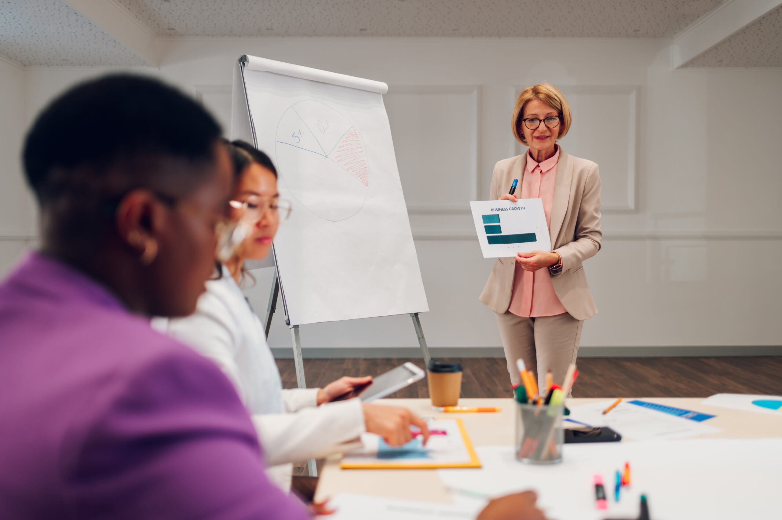 Senior businesswoman holding a presentation during a meeting in an office